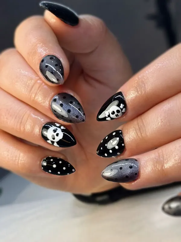 Black and grey almond nails with skull and polka dot art