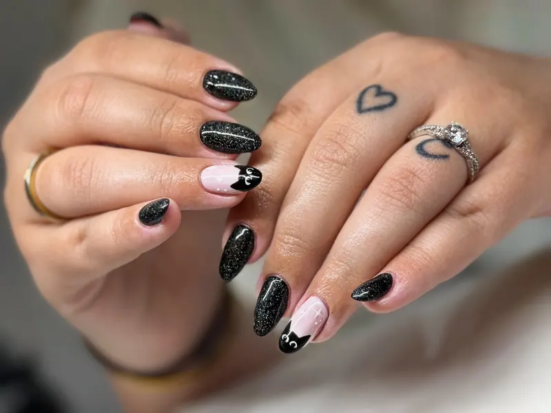 Black sparkle gel with pink cat accent nails