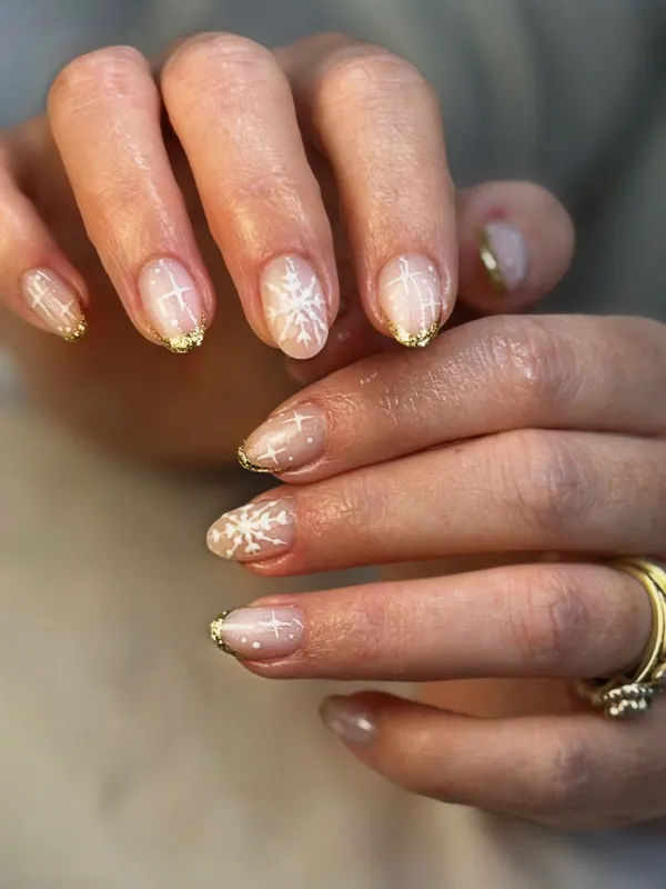 Nude gel with snowflake art and gold-edge tips